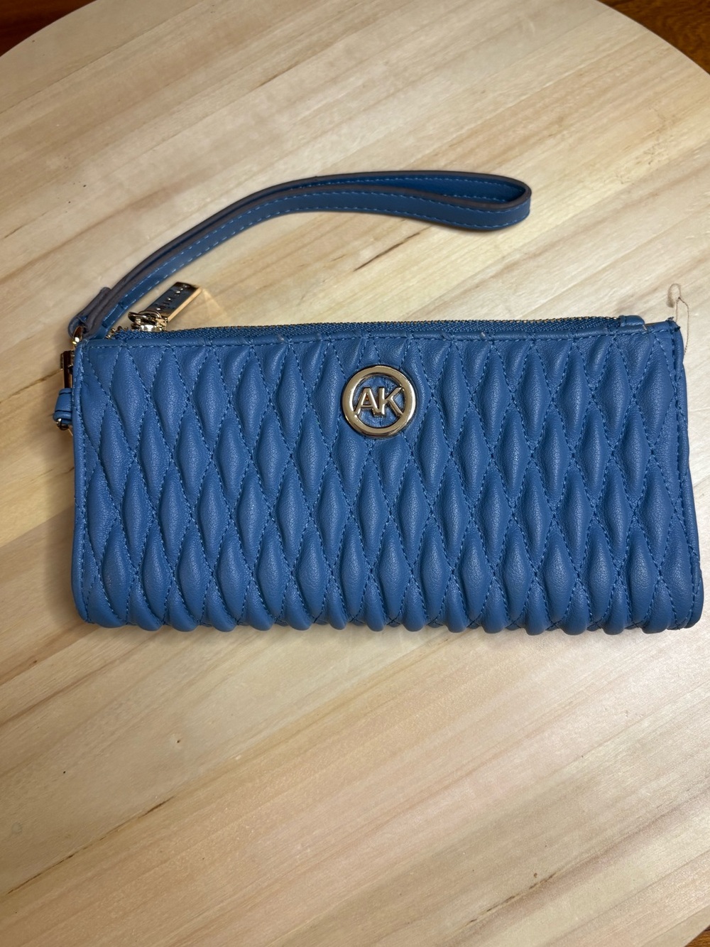 blue quilted Anne Klein wristlet wallet with gold hardware.